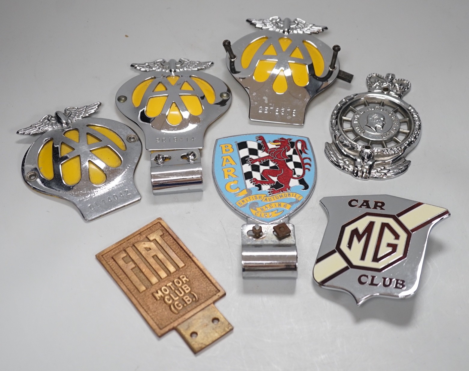 Seven car badges: Fiat motor club, British automobile racing club, MG club, the automobile club and three AA badges